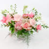 This brilliant arrangement of pink flowers brings some sunshine and vibrant color