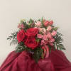 This arrangement includes roses, charmelia, and tulips and is featured in our