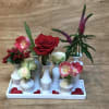 This stylish arrangement has 7 vases attached to a tray.  