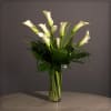 10 Medium Sized Calla Lillies with Tropical Greens in a Clear Glass