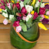 A beautiful mixture of Dutch tulips arranged in glass vase.