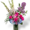 This marvelous arrangement has alliums, pink delphiniums, peonies, lilacs, hydrangeas, and greens