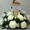 All white blooms surrounding a beautiful keepsake lantern with varying sentiments. All