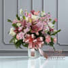 The Graceful Pink Tribute is a soft and elegant display of love
