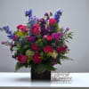 An uplifting expression of life and beauty, this arrangement overflows with hot