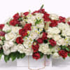 A lush and sophisticated floral arrangement designed in a modern white base