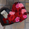 A two-tier heart box featuring lush red and pink roses and carnations