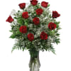 Wow with our dozen red long stem roses designed in a glass