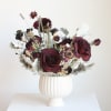 Black Velvet Bloom is a striking dried floral arrangement featuring deep red