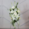 A standing easel spray of Asiatic lily, hydrangea, gerbera daisy, and snapdragon