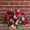 THIS ROMANTIC FRESH CUT FLORAL ARRANGEMENT IS FILLED WITH BRIGHT COLORS THAT