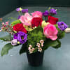 Red and pink roses, green hydrangea, green ball dianthus, purple lisianthus, orchid