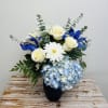 Fresh blooms of blue and white in a blue glass vase. A