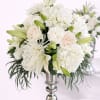 Timeless and sophisticated, this floral arrangement features white hydrangeas, whiteroses, lilies, and