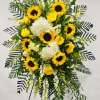Standing Spray with sunflowers, yellow roses, white snapdragons, white hydrangeas, solidago and