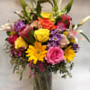This full arrangement comes complete with an array of roses, snapdragons, stargazer
