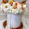 An elegant arrangement in a white flower box, featuring white hydrangeas with