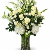 An elegant tribute vase of premium white blooms accented with lush, top