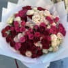 A breathtaking arrangement of premium roses in deep red, soft blush, and
