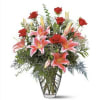 This romantic arrangement of lilies and roses will help to celebrate any