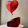 One dozen premium red roses, hand-wrapped with a red heart balloon for