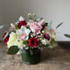 A striking fusion of luxury and romance, this handcrafted arrangement showcases lush