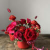 Modern arrangement of various blooms in shades of red in a red