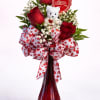 Sweetheart Surprise is a charming Valentines Day arrangement featuring classic red roses