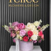 A lush luxury hatbox arrangement featuring premium peonies and garden roses in