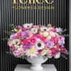 A lush garden-style floral arrangement featuring premium pink and blush roses, soft