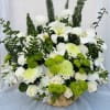 Beautiful basket arrangement featuring white lilies, orchids, carnations, roses, chrysanthemums, and green