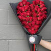 50 roses delicately placed to create a heart shape of roses and