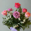 A beautiful assortment of 6 colored roses with babies breath and greens.