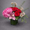 Timeless red roses paired with romantic pink blooms and fresh greenery, beautifully