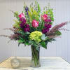 Tall vase arrangement of garden favorites, including pink heather, green hydrangea, purple