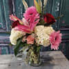 A lovely bouquet of sweet cabbage roses, lilies and gerber daisies in