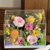 A vibrant preserved flower arrangement featuring a harmonious mix of roses, garden-style