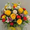 A cheerful and vibrant floral arrangement featuring bright yellow roses accented with