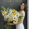 A bright and joyful yellow and white flower bouquet designed to bring