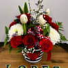 Fresh tulips and long stem red roses in a heart painted tin