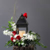 This beautiful sympathy flower arrangement is adorned with a cardinal on a