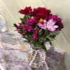 Red rose, mums, dianthus make a pretty little arrangement