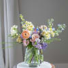 A softly expressive garden-style arrangement featuring a curated blend of pastel blooms