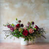 A classy and elegant arrangement in a jewel toned color palette for