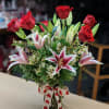 Amazing mix of 6 roses and 2 stems of beautiful oriental lilies.