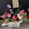 Lush flowers arranged like a centerpiece in festive Valentine's Day colors available