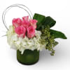 Gorgeous arrangement of pink roses, white hydrangeas, seeded eucalyptus, and bear grass.