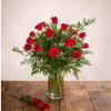 This elegant vase features a stunning arrangement of vibrant red roses, adding