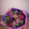 Enhance any room with our stunning bouquet of purple and pink flowers