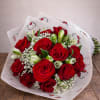 A charming and elegant bouquet featuring lush red roses paired with delicate
